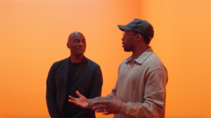 Film still of Woody De Othello discussing ‘Faith Like a Rock’ with Ekow Eshun, Stephen Friedman Gallery, London (2024). Courtesy of the artist and Stephen Friedman Gallery, London and New York