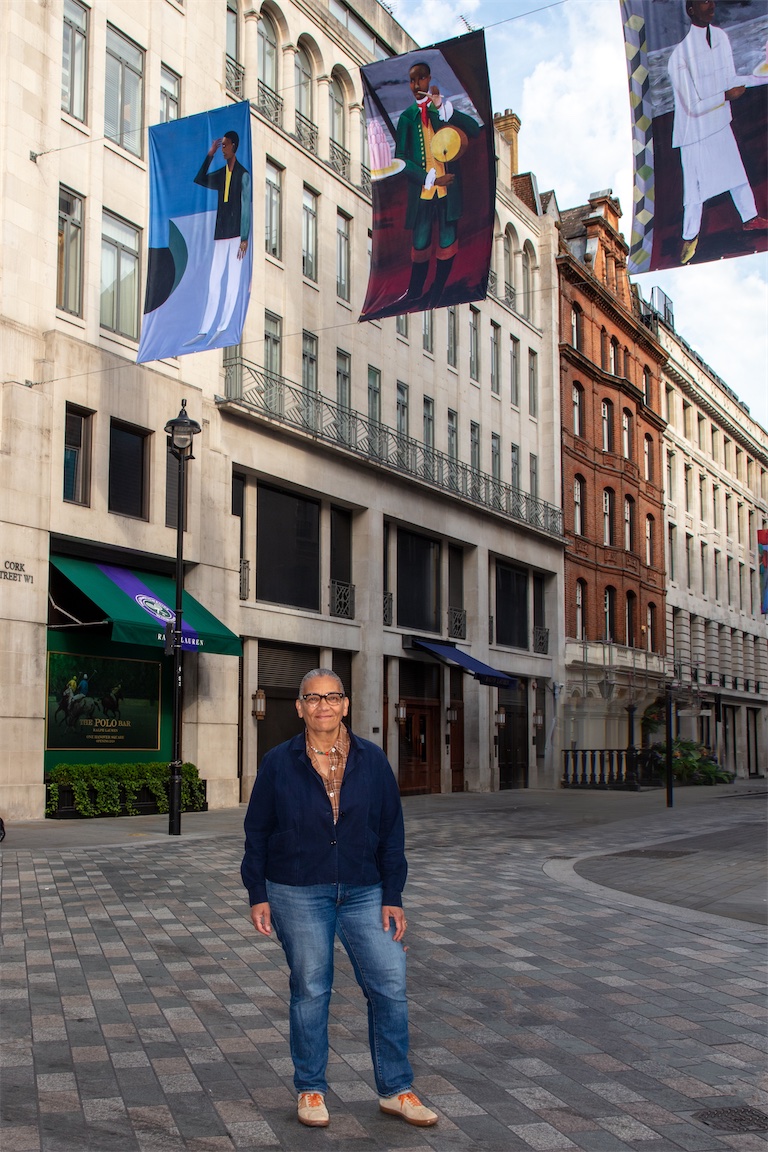 Lubaina Himid photographed with ‘Reading the Label’, Cork Street Galleries Banners Commission 2026. Courtesy Cork Street Galleries and The Pollen Estate. Photo: Luke Hayes